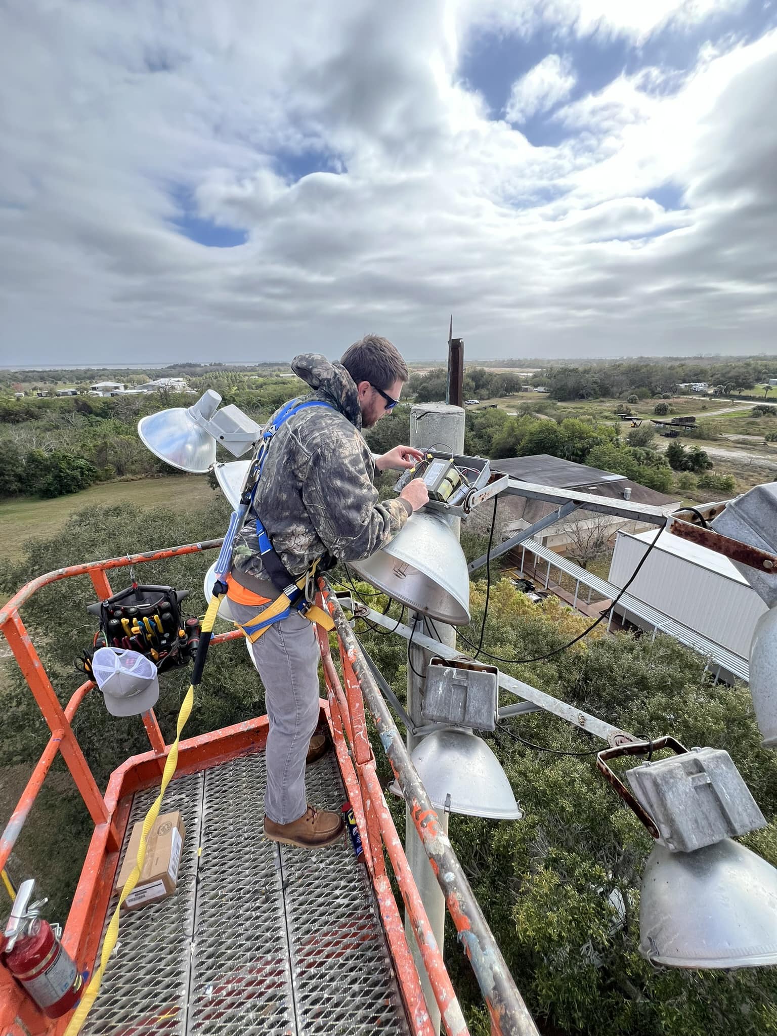 Hardy Electrical licensed electrician working on commercial lighting at height in Brevard County, FL